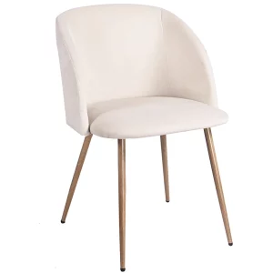 Chaise en velours crème avec dossier en forme de halo posée dans un intérieur lumineux