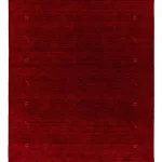 Petit tapis rouge profond aux motifs géométriques rappelant des vitraux anciens